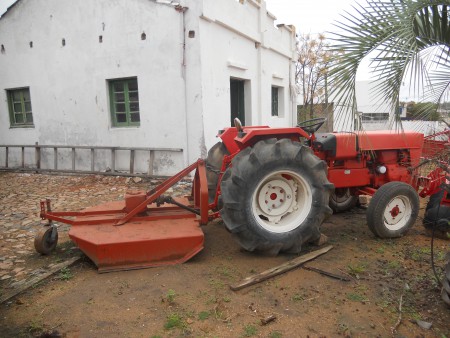 Trator Agrale equipado com  roçadeira, arado, grade e plataforma.